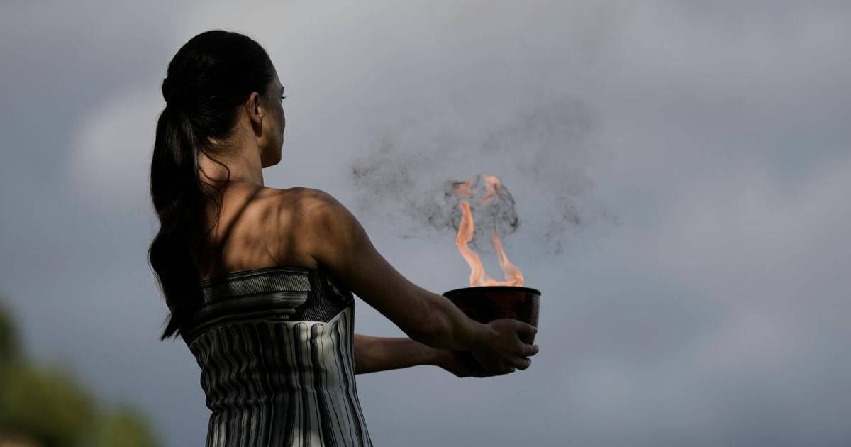 Under a cloud, the Olympic flame begins its journey to the Milan Cortina Winter Olympics
