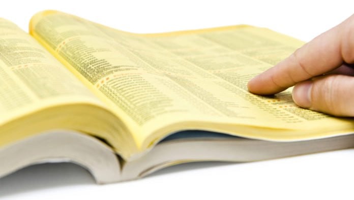 Member Of Marginalized Group Searches Phone Book For Local Business To Be Oppressed By