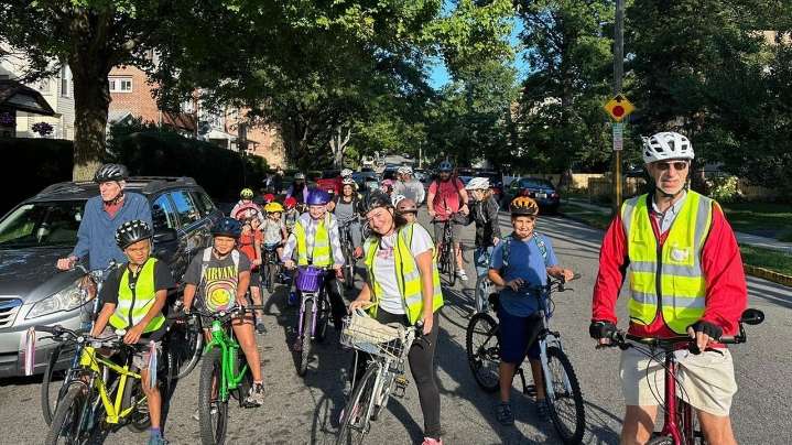 From a few to more than 350, children and parents ride together to school as a 'bike bus'