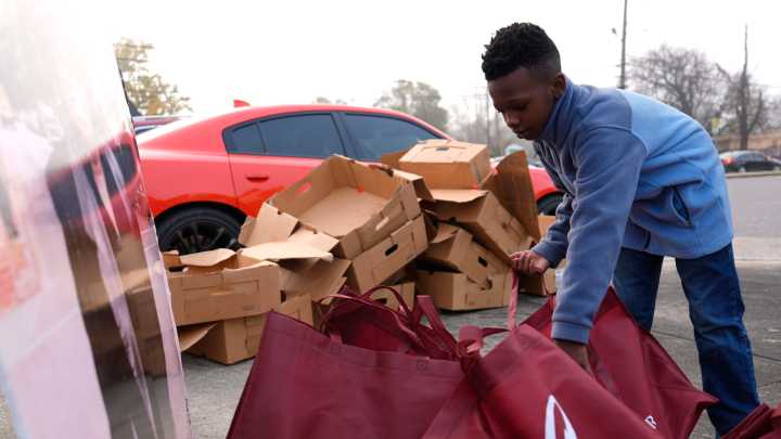 SEE IT: Volunteers pass out turkeys for James Brown Turkey Giveaway