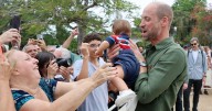 Prince William cuddles babies and takes selfies as he's mobbed by screaming fans