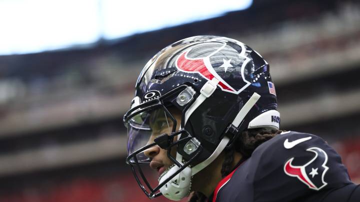 C.J. Stroud leaves for a concussion check after being hit as he slid