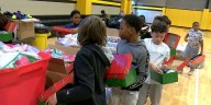 Fourth grade students in Tuscaloosa pack boxes of cheer for Christmas