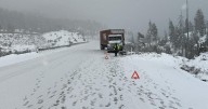 Snow, jackknifed big rig among Sierra I