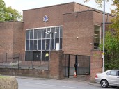 Man arrested in connection with synagogue attack after arriving on flight