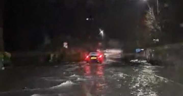 Moment cars send 'small waves' along Midlands road flooded by Storm Claudia