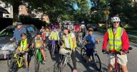 From a few to more than 350, children and parents ride together to school as a ‘bike bus’