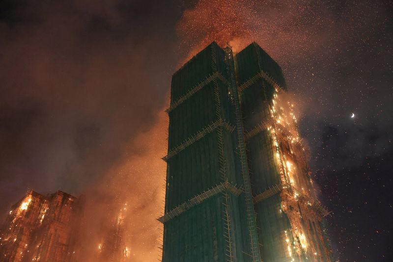 At least 13 dead after fire engulfs residential high-rise buildings in Hong Kong