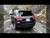 Boulder slams into driver's Jeep during rain in SoCal mountains
