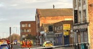 City centre street closed for hours as man on roof