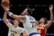 Sluggish Lakers trounced by short-handed Hawks to end winning streak