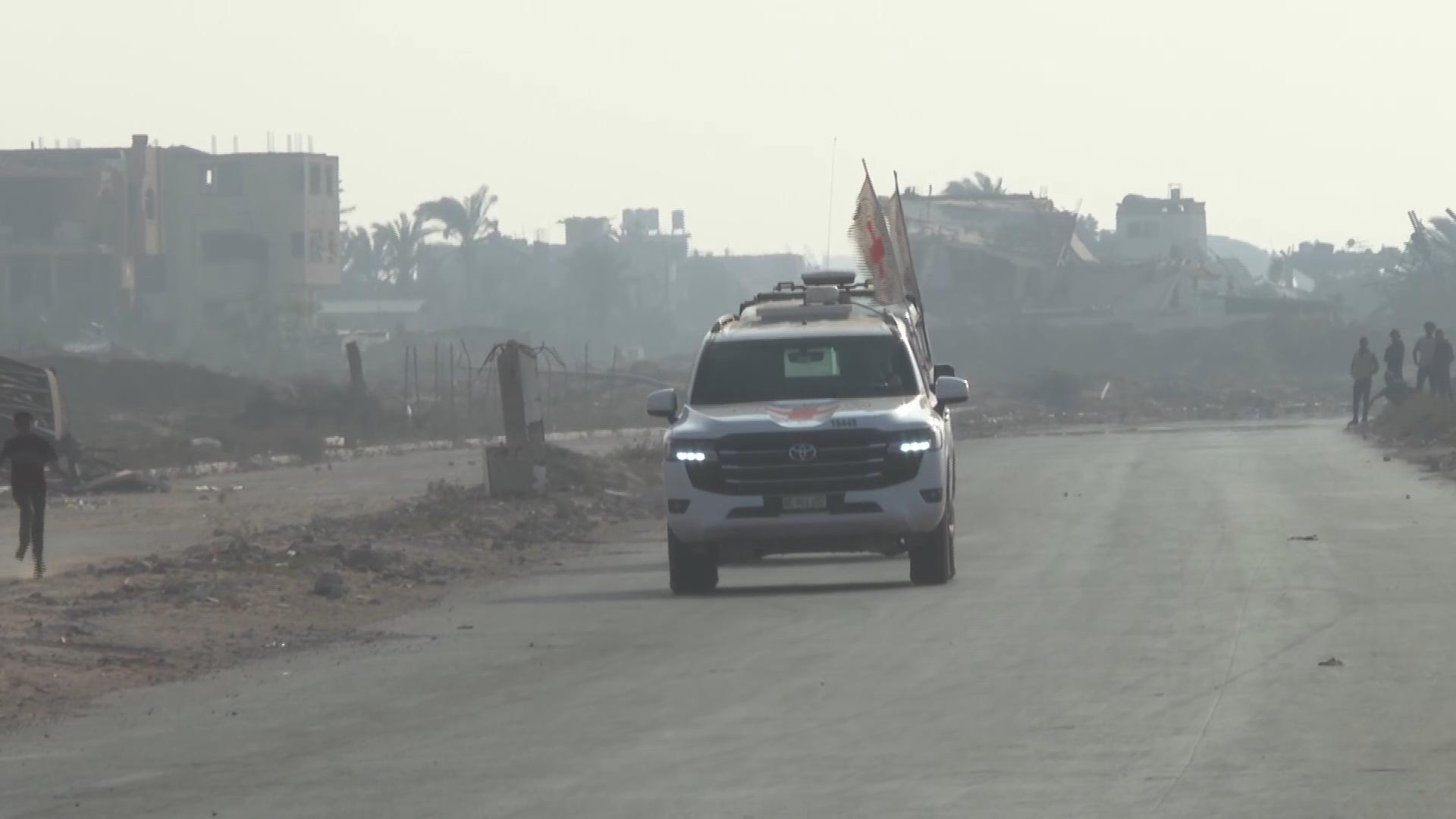 Red Cross vehicles carrying what is believed to be the remains of a hostage drive in central Gaza