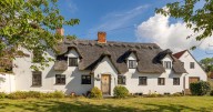 Chocolate box thatched cottage on the market in 'picturesque village'