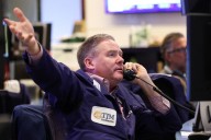 Dow falls 100 points while Nasdaq rebounds from tech rout