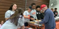 Gilmer student athletes serve Thanksgiving meals to community