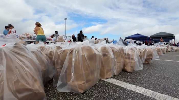 ‘Testament to this community:’ Volunteers rally at Daytona International Speedway for SNAP food drive