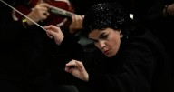 Photos of the first female conductor to lead a Tehran Symphony Orchestra performance