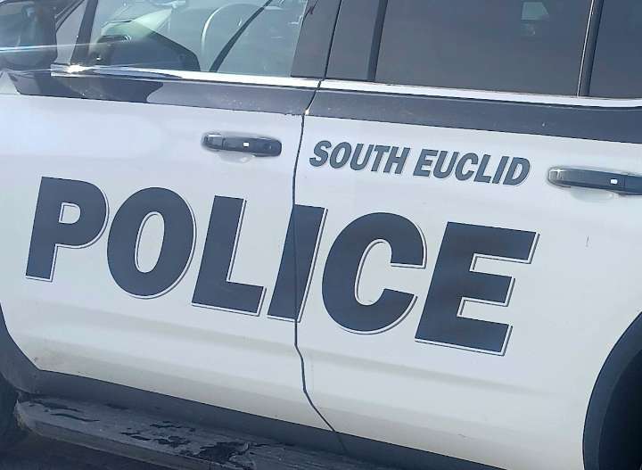 Man takes souvenir from police cruiser after arrest at South Euclid Walmart