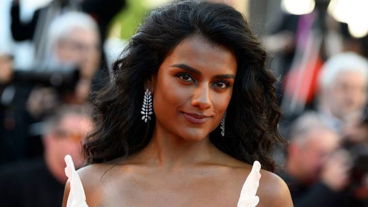 Simone Ashley perfects autumn dressing in sheer tights, over-the-knee boots and a burgundy leather jacket