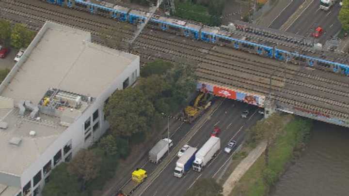 Truck carrying excavator hits two Melbourne overpasses within hours
