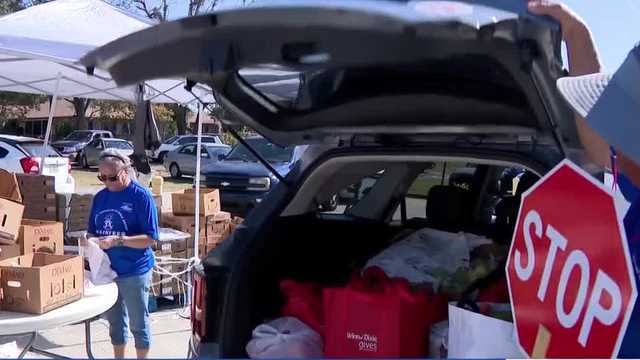 Families wait in line for Winter Park Thanksgiving food giveaway