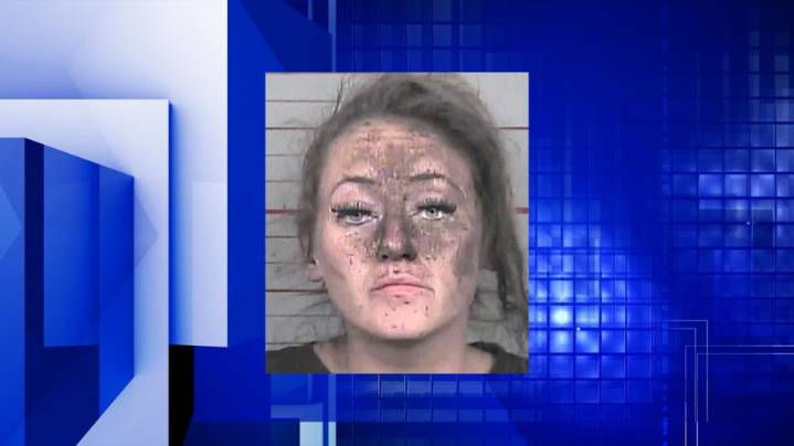 Iowa woman arrested after she was found between walls of business