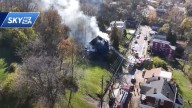 Crews battle large house fire in Newport; smoke plume visible from miles away