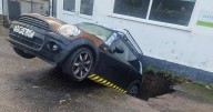 Mini in danger of being 'eaten' by giant freak sinkhole