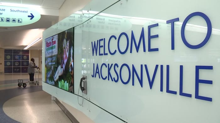 Travelers share post-Thanksgiving experiences at Jacksonville International Airport as they head back home
