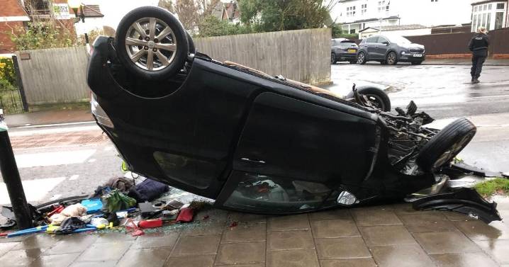 Dramatic scenes as car flips onto roof in busy Bristol street