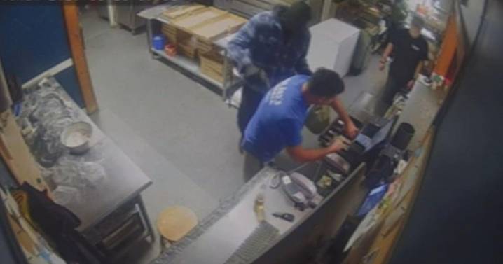 Video shows man robbing pizza restaurant at gunpoint in Dover, New Hampshire