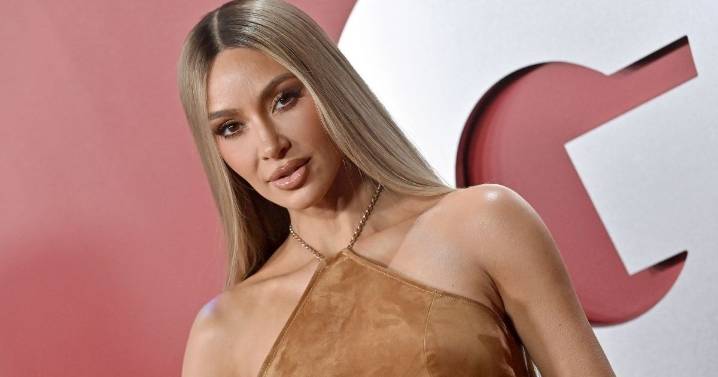 Kim Kardashian Floats in Water Wearing Bold Dress