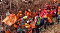 Indonesian rescuers search for nearly three dozen people after landslides killed at least 18 people