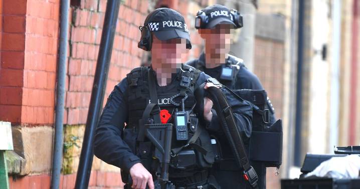 Armed police and negotiators swarm street after 'domestic incident'