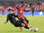 10-man Canada holds on for goalless draw with Ecuador