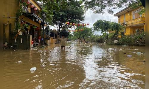 Vietnam floods kill 41 as record rain sweeps away bridge, leaves families stranded on rooftops