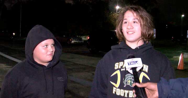 Two young superfans arrive hours early to cheer on big brother in high school playoff game