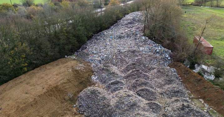 Massive 500ft-long illegal waste heap captured in shock pictures as man arrested