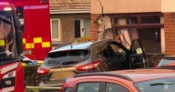 Car smashes into house in Scots town as police tape off street