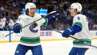 Canucks score five third-period goals to beat Lightning, end three