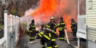 Firefighters battle garage fire in Hartford