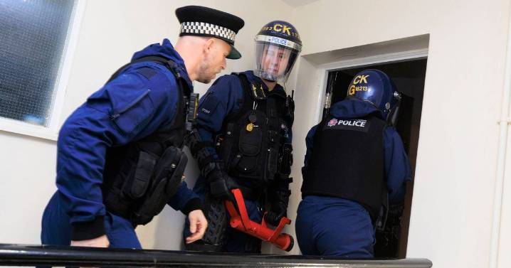 Cops swarm suburb in early morning raid and arrest 15