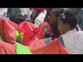 Children pack bags full of essentials for people in need