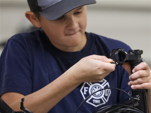 Families build traditions of giving back by building bikes
