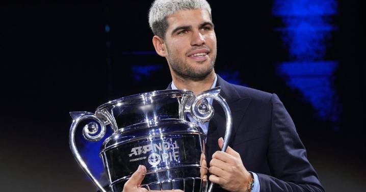 Carlos Alcaraz beams with pride as he lifts trophy for year