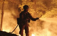 California wildfire grows as storms threaten Los Angeles with floods
