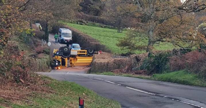 Gritter lorry pictured on its roof as road remains closed hours later