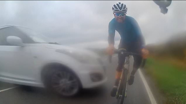 Heart-stopping moment cyclist narrowly avoids being hit by skidding car