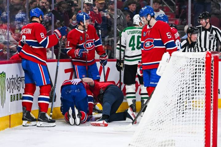 Canadiens F Alex Newhook helped off ice after collision with boards