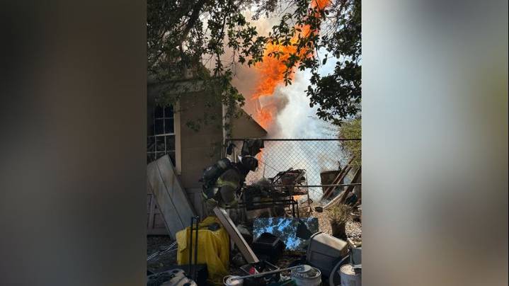 Firefighters work to extinguish house fire on Iberia Street